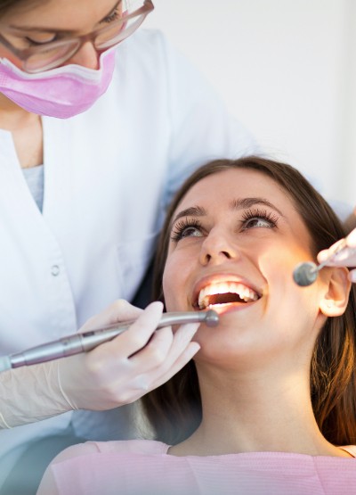 Woman receiving dental checkup and teeth cleaning treatment
