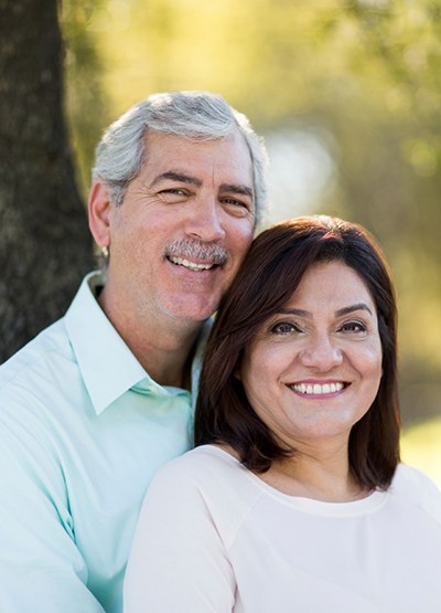smiling couple with dental implants in Conroe 