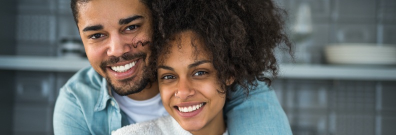 Man and woman with healthy smiles after restorative dentistry