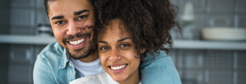 Man and woman with healthy smiles after restorative dentistry